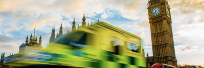 Image of a fast ambulance driving in front of Big Ben